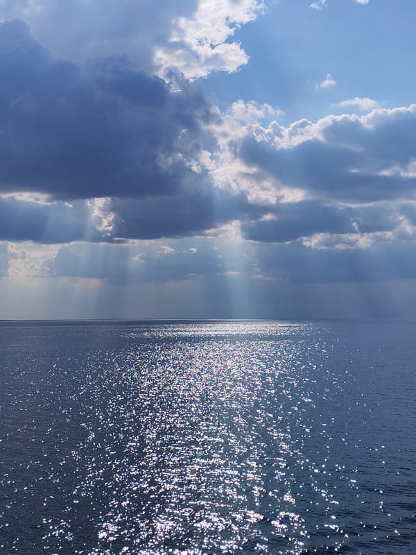 Dramatic sunbeams pierce storm clouds over Belozersk waters