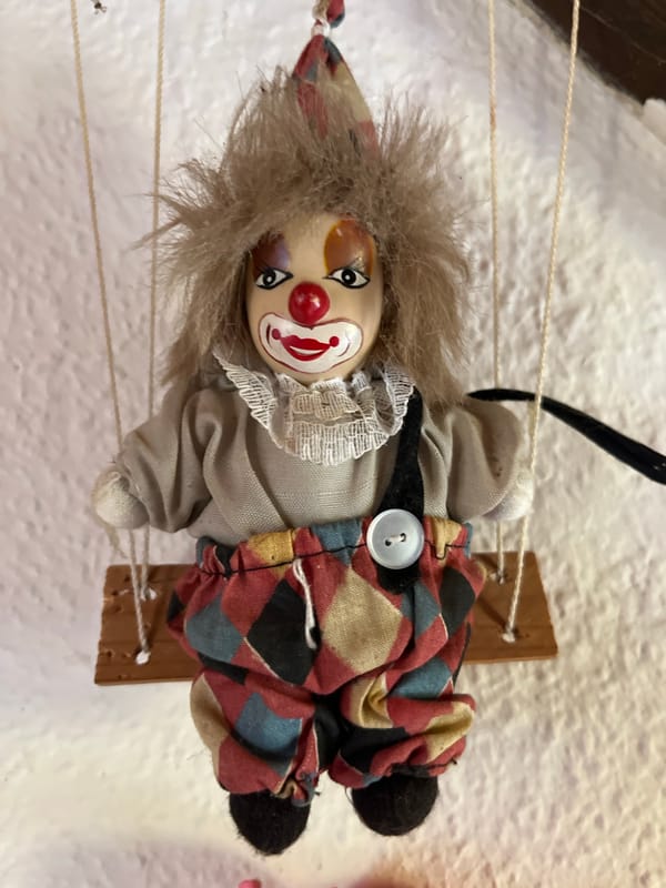 Eclectic personal collection of dolls, horror figures, and curios
