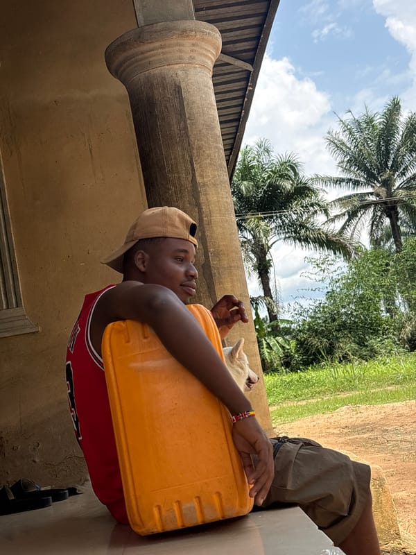Man rests on ledge during midday in Ikot Ekpene