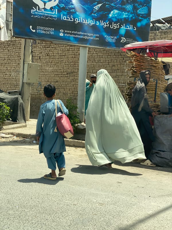 Everyday street life across a commercial district in Kandahar