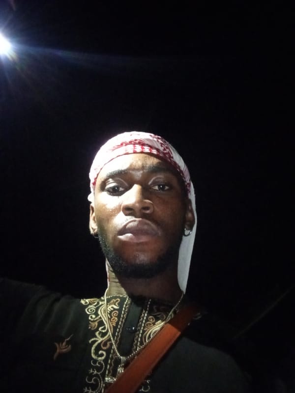 Man in traditional dress photographed at night in Lokoja