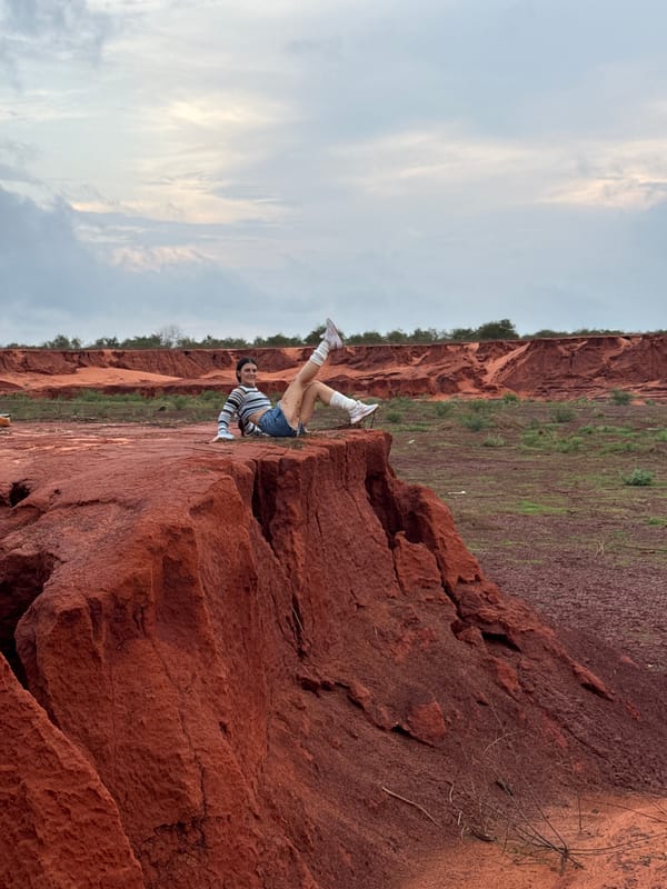 Tourist explores dramatic red sand formations in Mui Ne