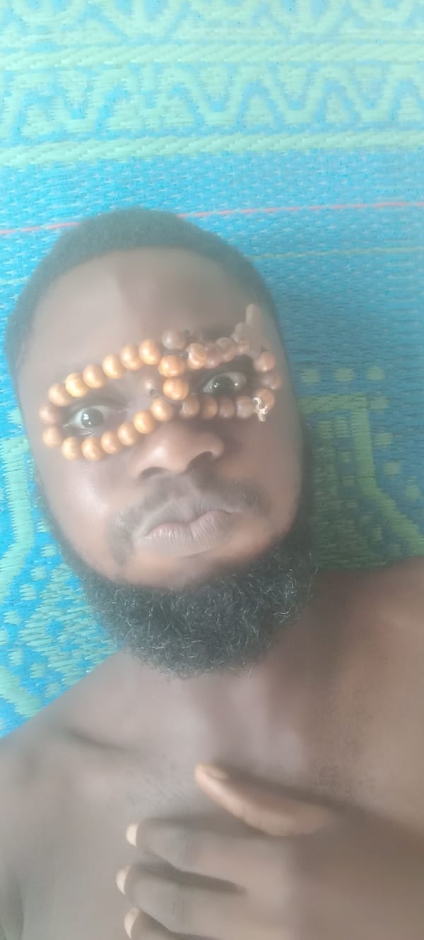 Man rests on mat in Bende, Nigeria
