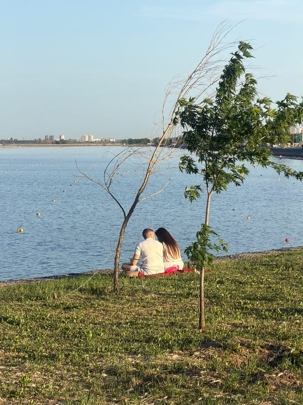 Two people photographed by lake with buoys in Rostov-on-Don
