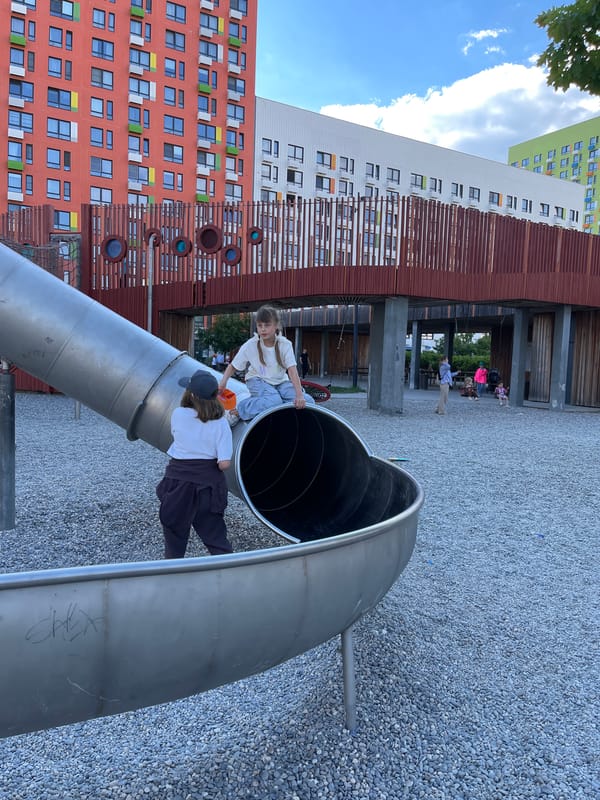 Children play at sunny Kommunarka playground amid residential development