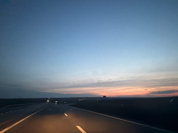 Highway captured at dusk in Romania showing colorful twilight sky
