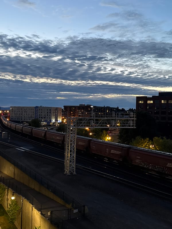 BNSF freight train moves through Vancouver, WA at dusk