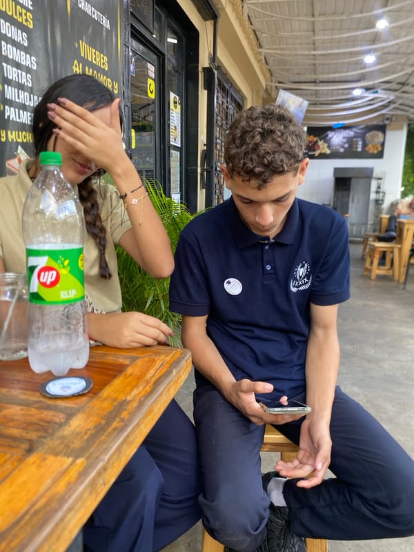 Everyday street life around a covered outdoor dining spot