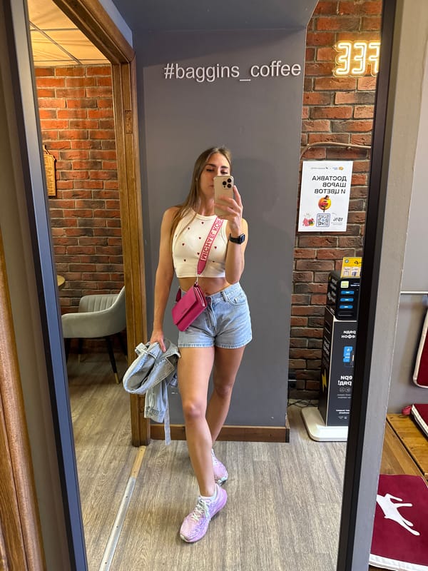 Mirror selfie in a Saint Petersburg café, heart-print outfit