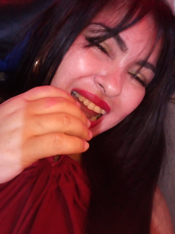 Woman takes selfies in Juan Griego during early morning hours