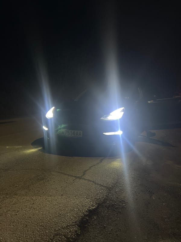 Car with headlights on captured in evening scene