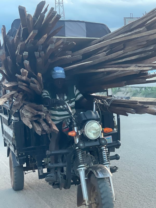 Heavy loads and street hustle in Onitsha at dusk