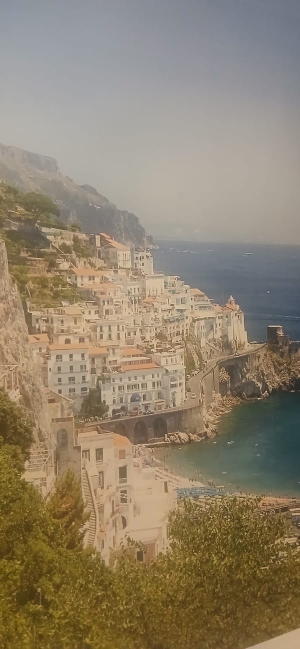 Coastal hillside town with white buildings documented by witness