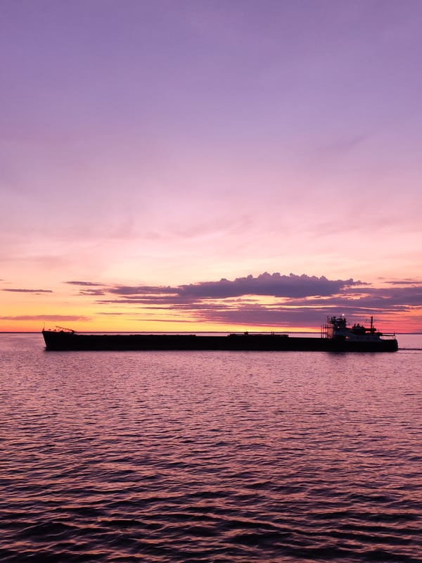 Barge crosses Russian waters during vibrant sunset display