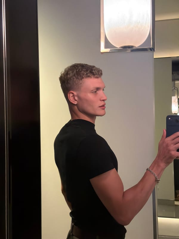 Mirror selfie in London, black tee and silver bracelet.