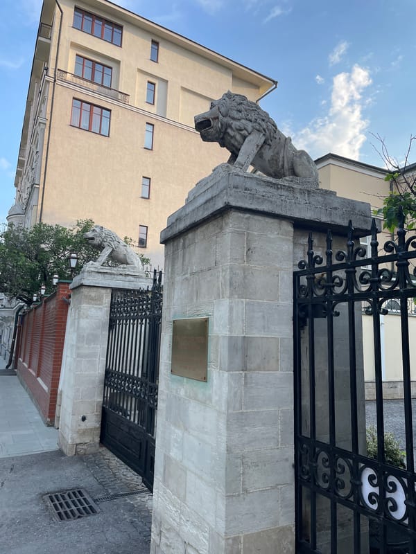 Moscow street scenes captured: lion statue entrance, sidewalk cafe