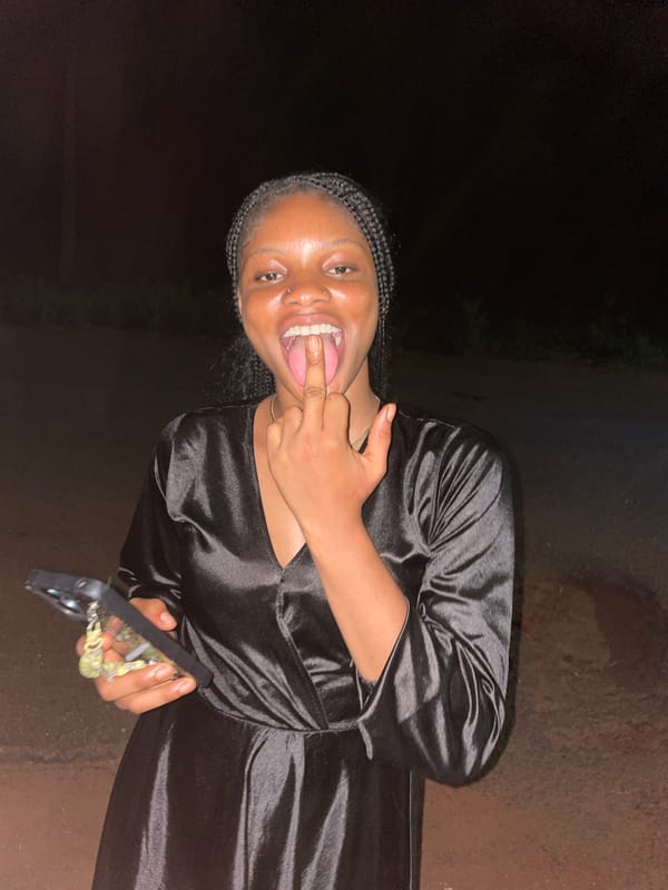 Woman poses for nighttime photos in Ogbe, Nigeria