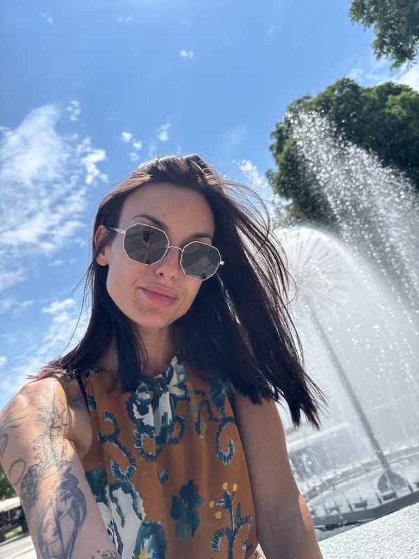 Woman takes selfie at active fountain in Pleven park