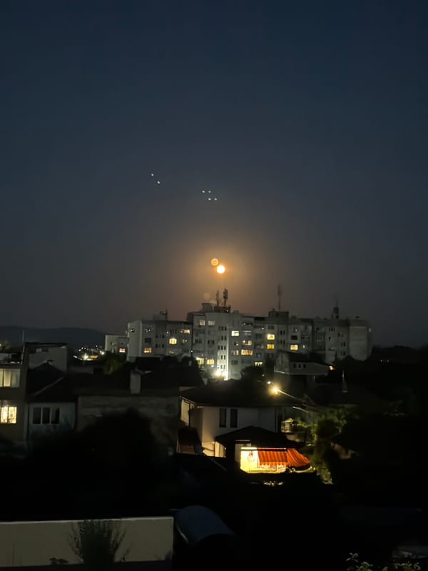 Bright orange moon rises over Burgas on a clear June night
