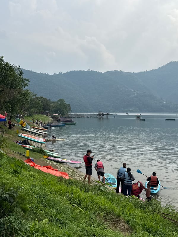Paddleboarding activity observed at Nepal's Phewa Lake under cloudy skies