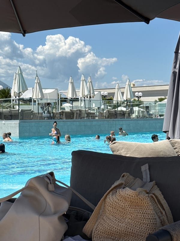 Resort guest enjoys poolside morning with breakfast and sunbathing