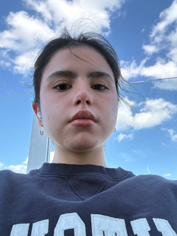 Portrait photo taken in Austin shows person in blue sweatshirt