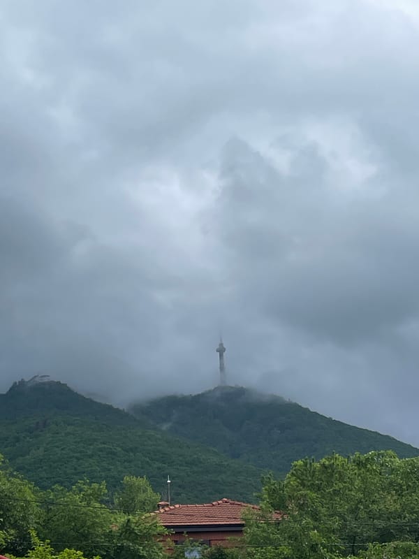 Mountain communications tower emerges from heavy fog