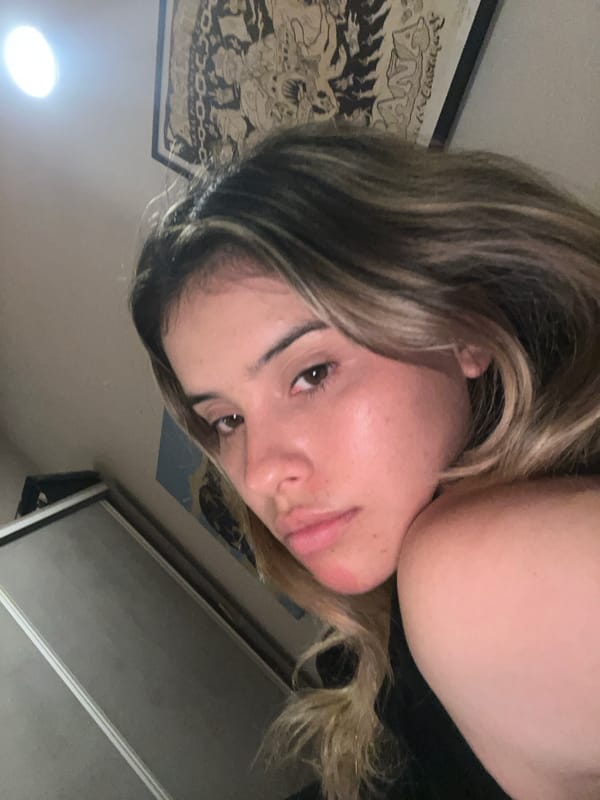 Woman records selfies in bedroom in Sumalao, Argentina
