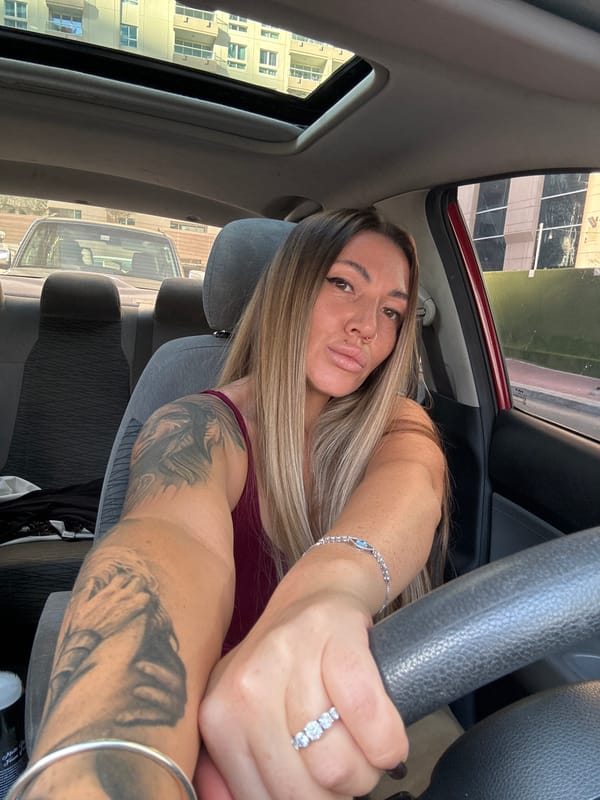 Woman with tattoos observed in driver's seat of parked car