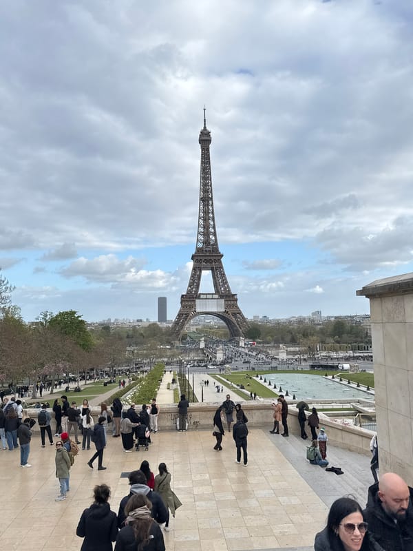 Eiffel Tower photographed against cloudy Parisian sky
