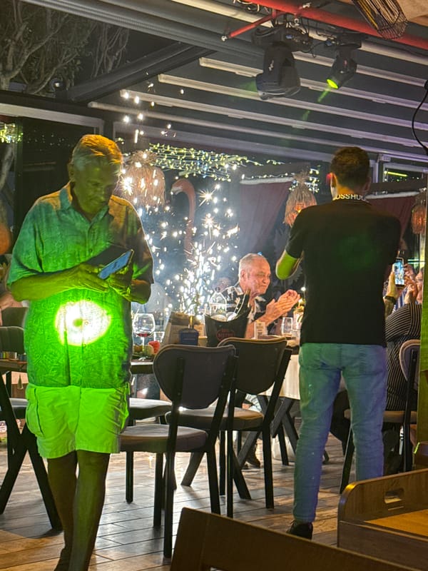 Evening dining venue bustles with music, sparklers, socializing