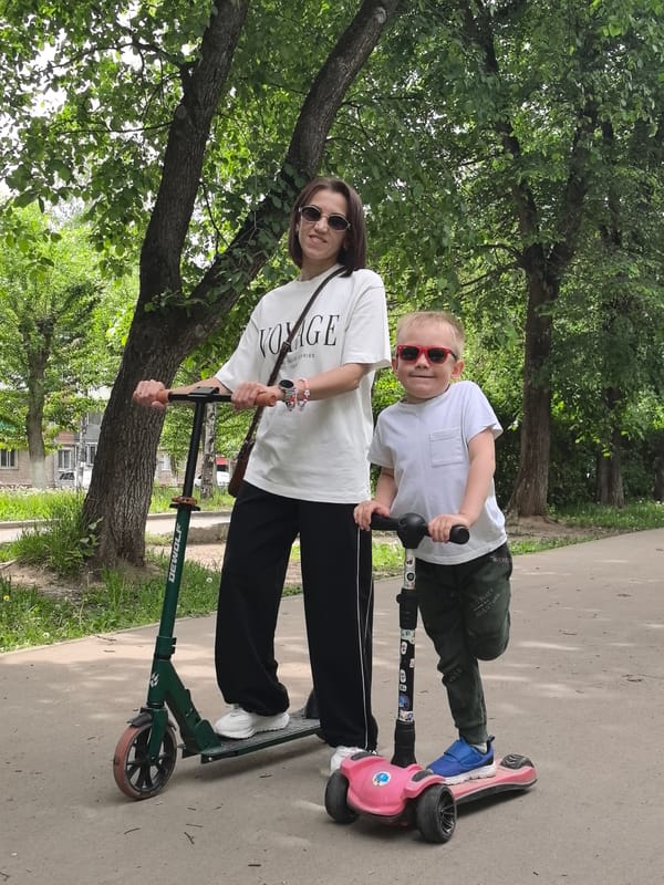 Mother and son pose with scooters in Perm
