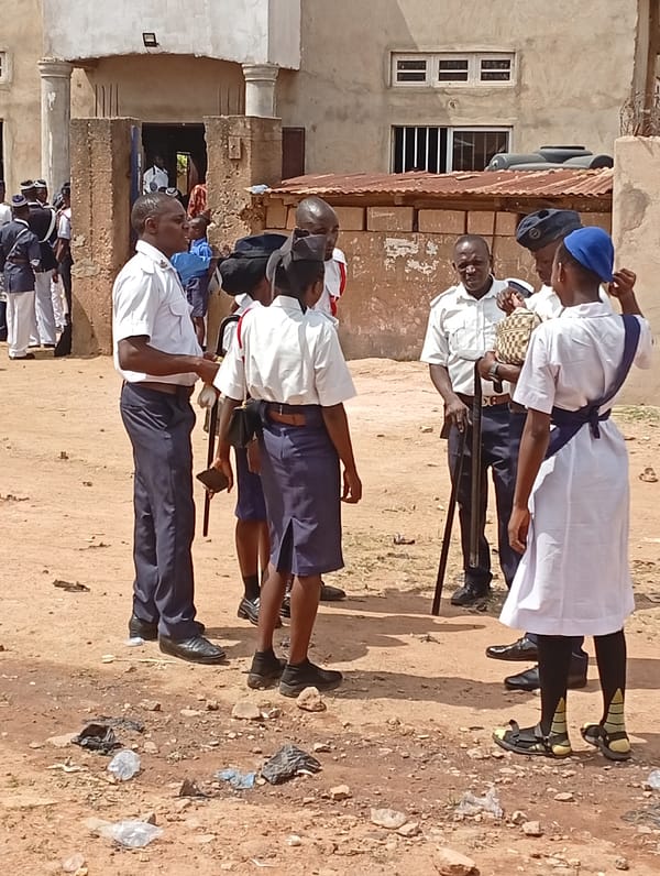 Uniformed personnel gather in outdoor formations during morning hours