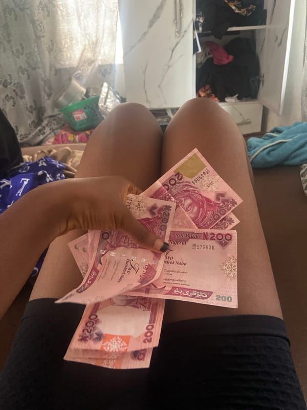 Person counts Nigerian banknotes in Lokoja
