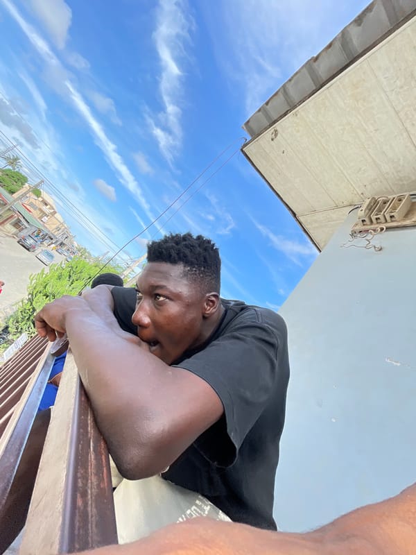 Young man documents street life from Ado balcony