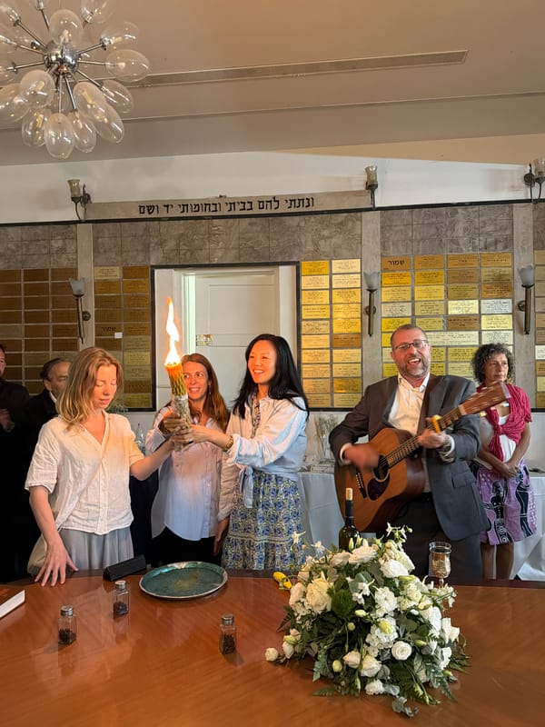 Indoor candle ceremony with women and man in Tel-Aviv