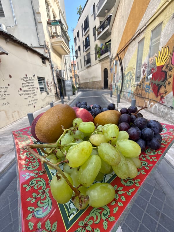 Fruit trays and street details in a Tel Aviv alleyway