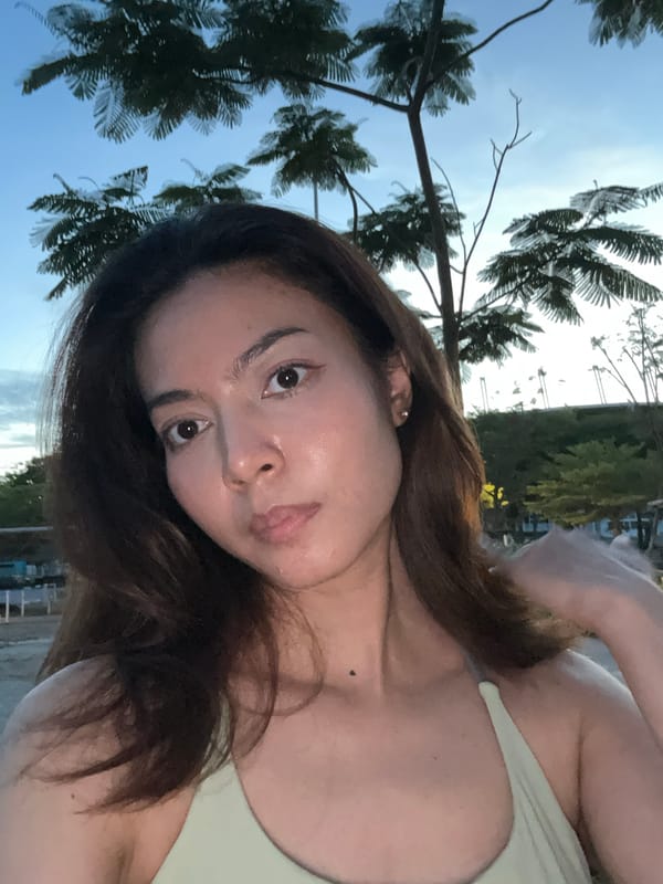 Woman takes outdoor selfies in Thailand during twilight hours