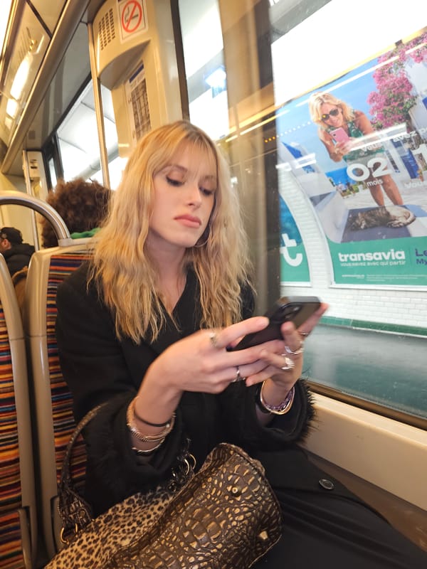 Woman sleeps, uses phone on Paris public transport