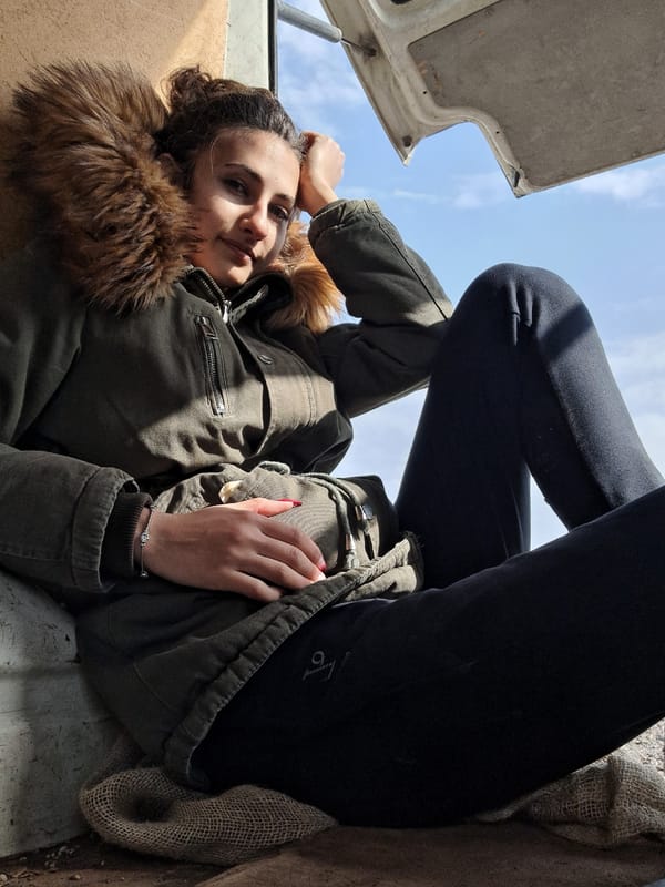 Woman rests during spring farming activity in Bulgarian village