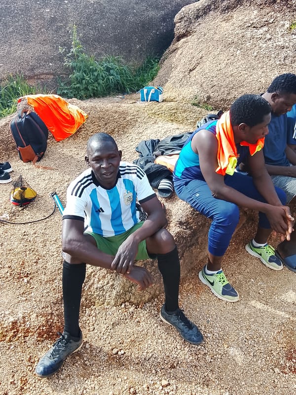 Group gathered on rocky ground in Jos, Nigeria