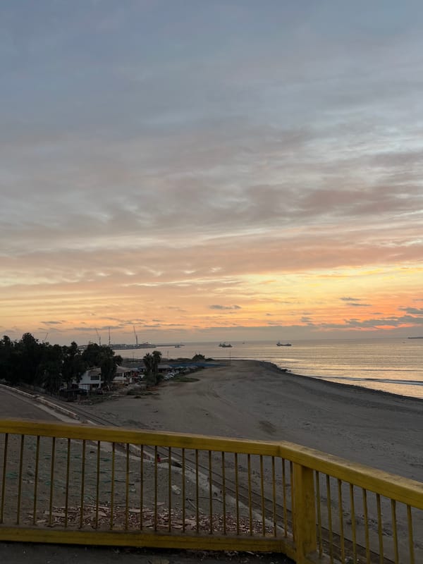 Sunset over Arica's coastline amid active high-rise construction