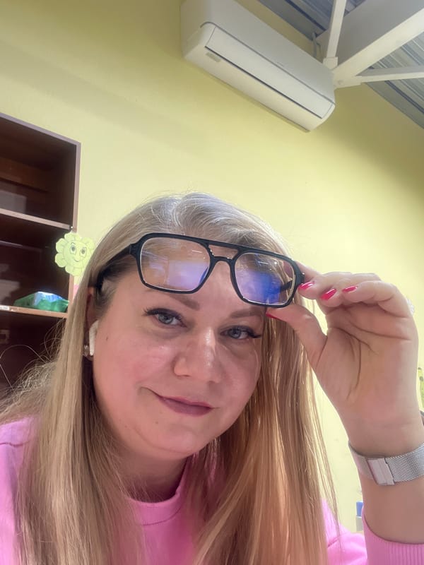 Woman takes selfies while adjusting glasses in Izhevsk office