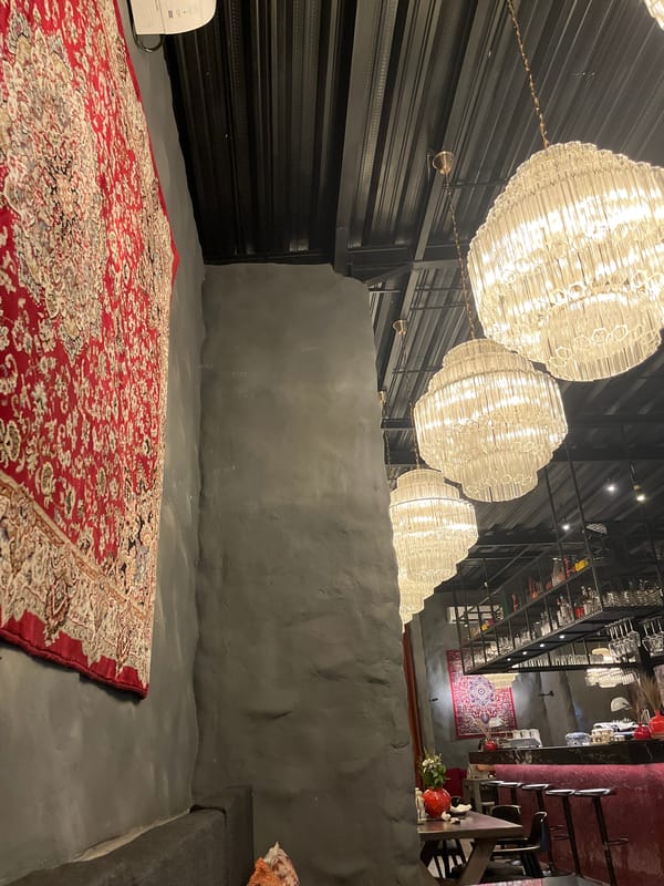 Indoor platform space with patterned rug documented in Ubud