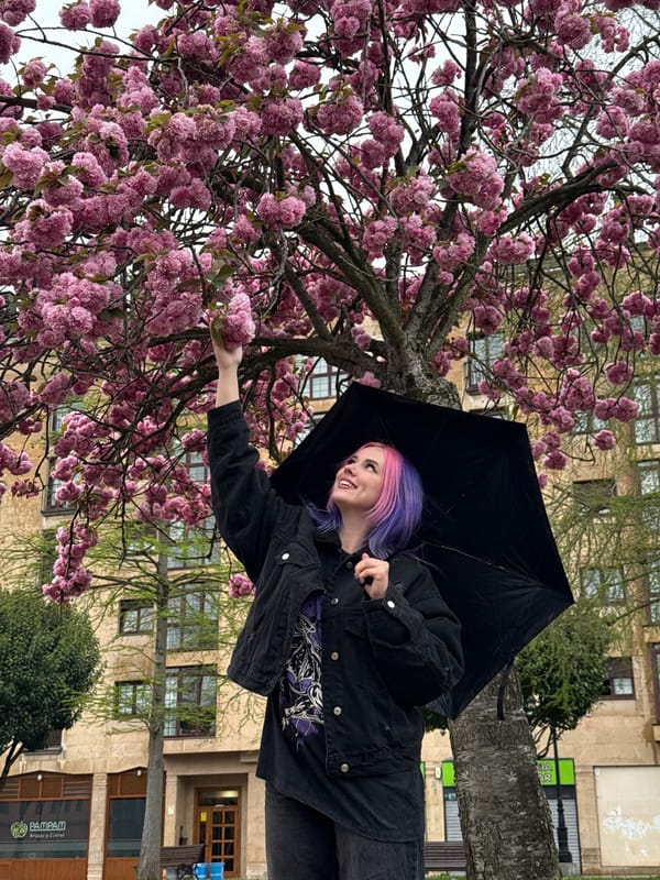 Woman poses with cherry blossoms in Oviedo park