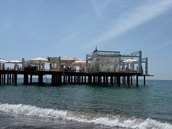 Pier with umbrellas and lounge chairs documented in Serik