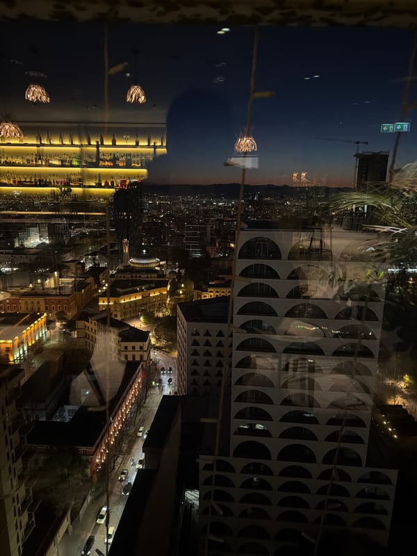 Piano performance captured alongside Tirana nighttime cityscape views