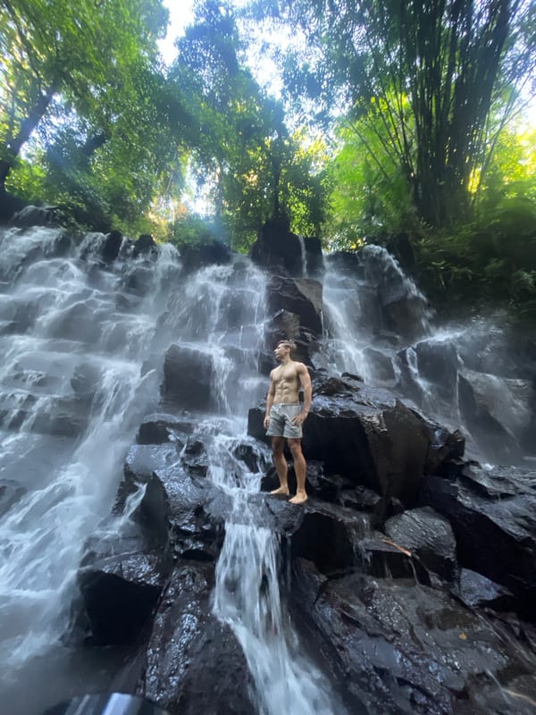 Tourists enjoy waterfall recreation in Gianyar, Indonesia