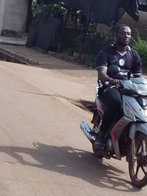 Man rides gray scooter in Tamale, Ghana