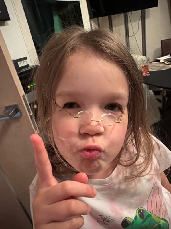 Girl makes pouting gesture while pointing in Saint Petersburg
